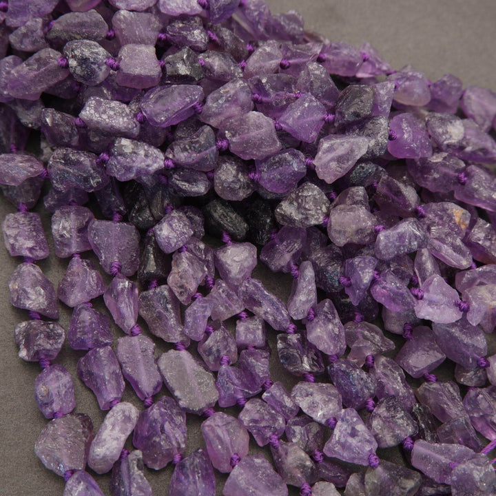 Close-up of purple crystal beads on a gray background