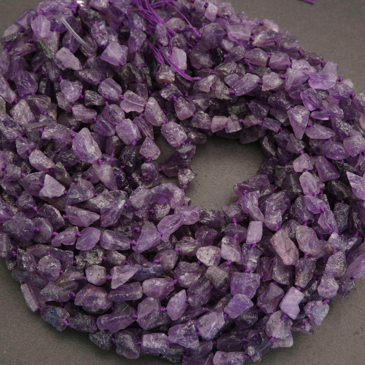 String of purple crystal beads on a gray background
