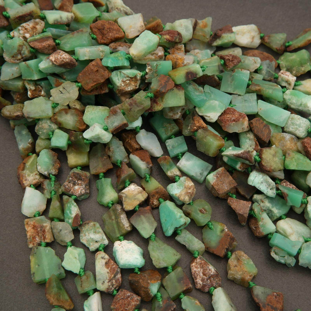 Necklace made of green and brown stone beads on a brown background