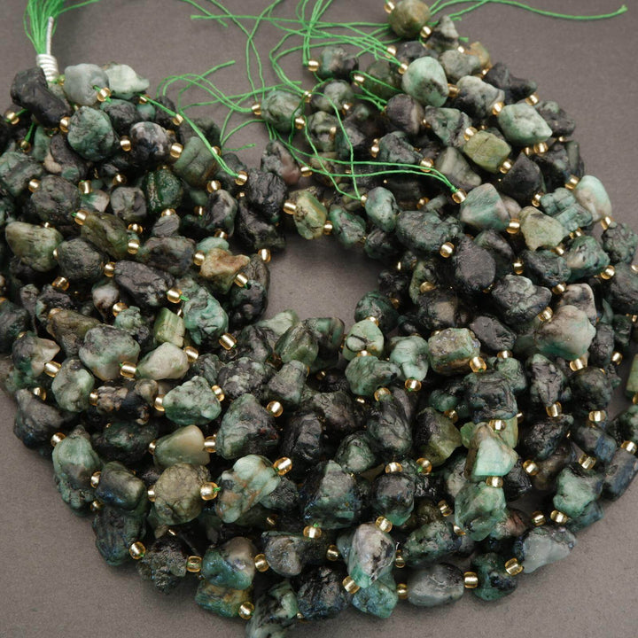 String of green and black beads on a gray background