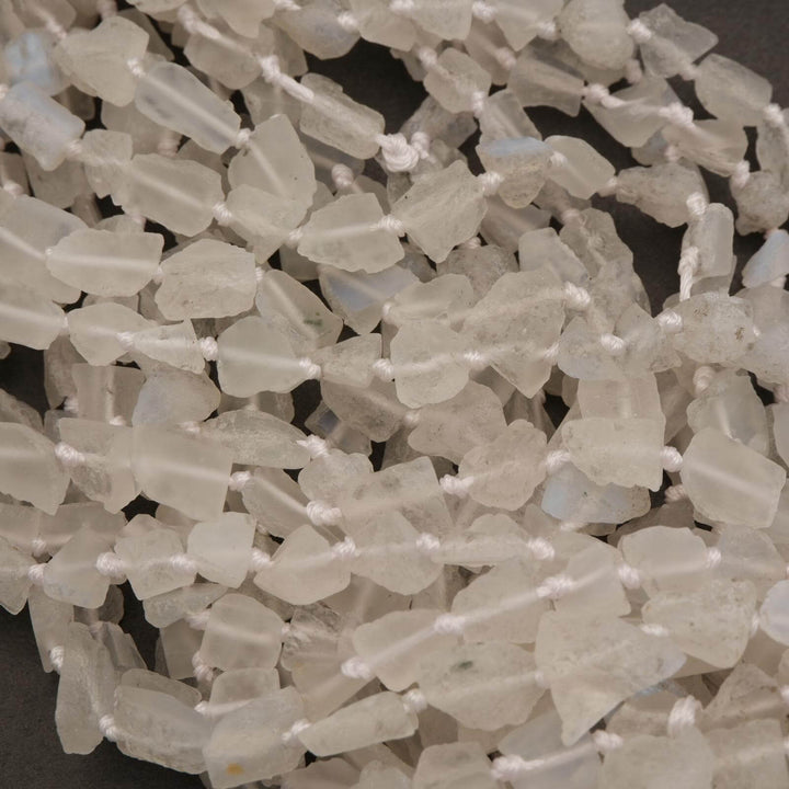 Close-up of a string of light-colored beads on a dark background