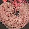 String of pink beads on a dark background