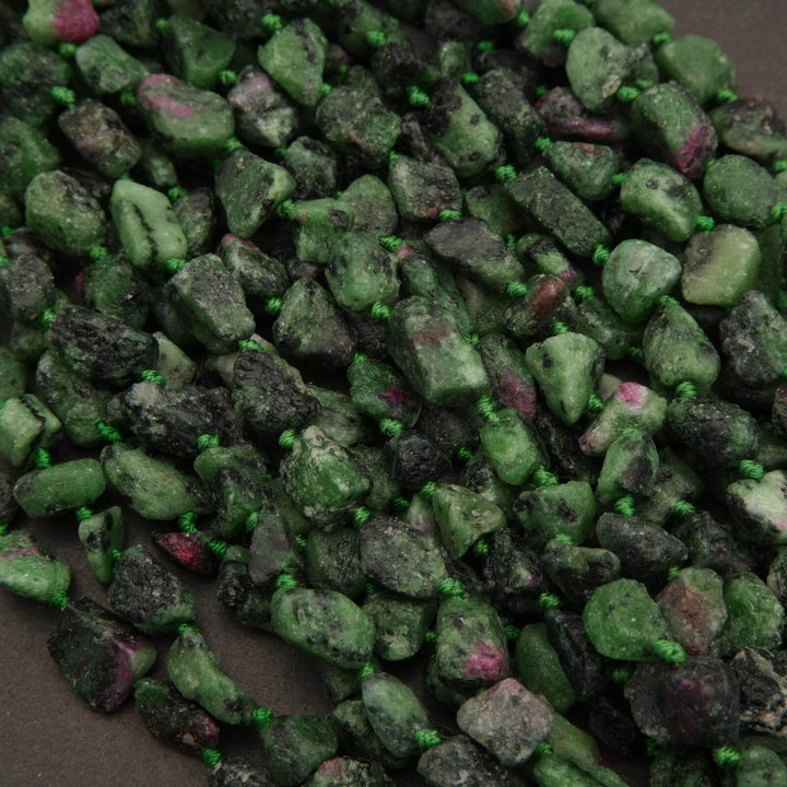 Close-up of green and black stones with a dark background