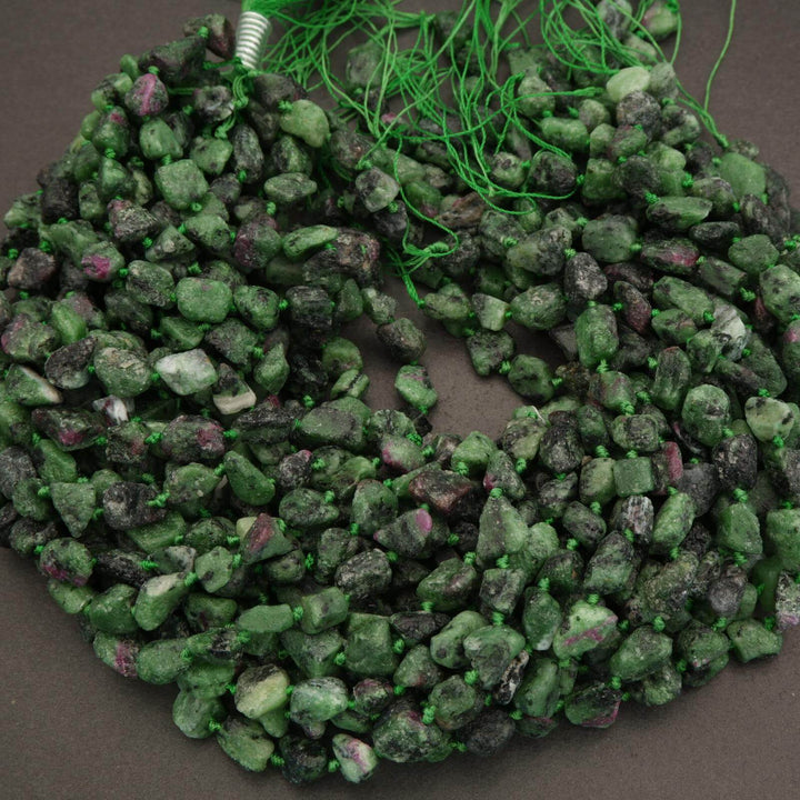 Green stone beads on a dark background