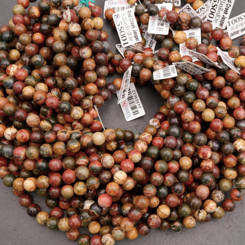 Multicolored marbled beads with price tags on a gray surface
