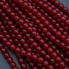 Close-up of red beads on a dark background