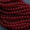 Close-up of red beads on a dark background