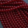Close-up of red beads on a dark background