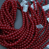 Red beads with price tags on a gray background