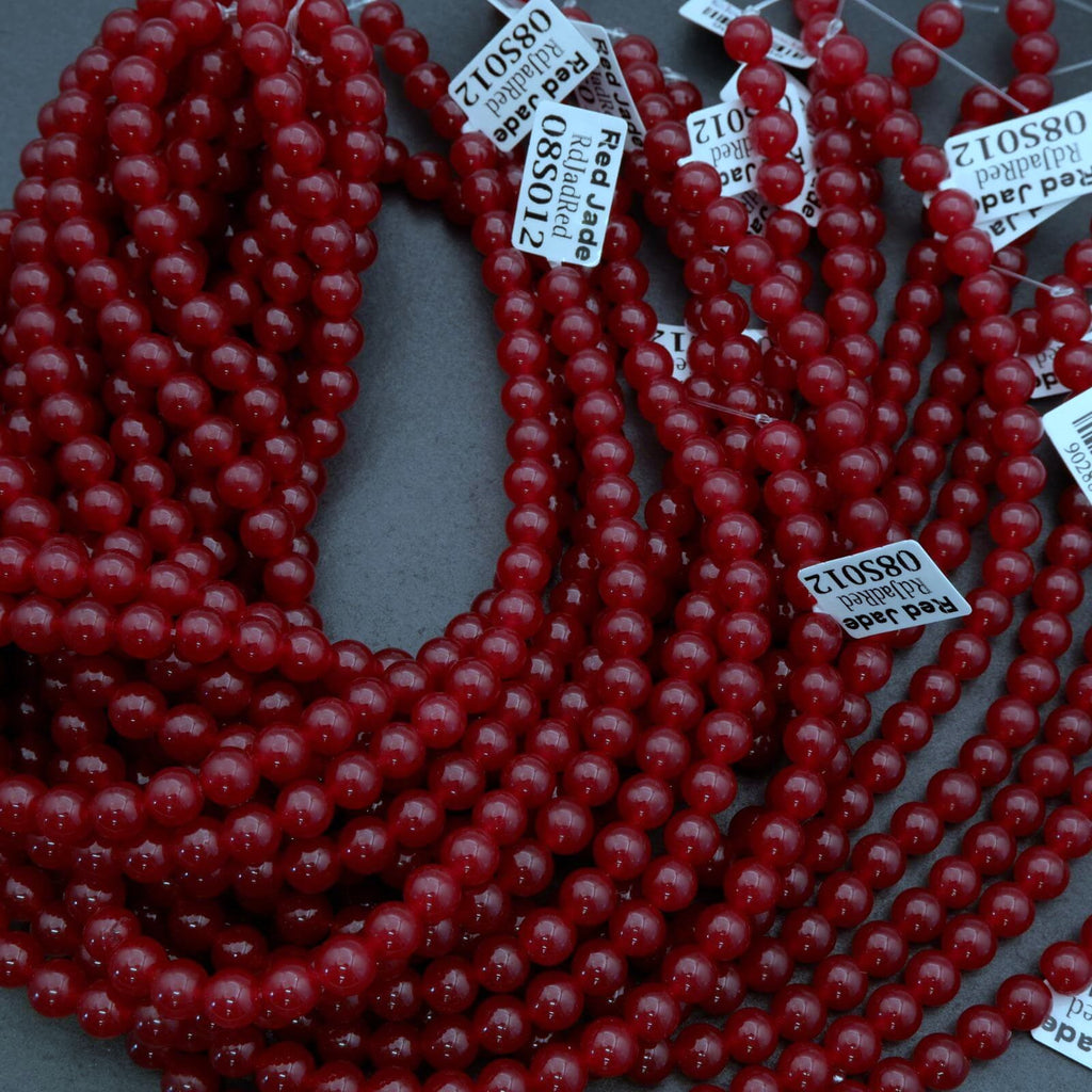 Red beads with price tags on a gray background