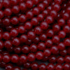 Close-up of red beads on a dark background