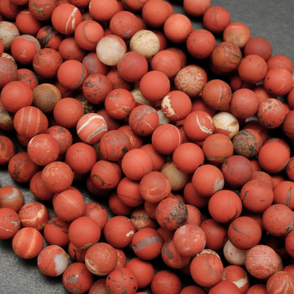 Close-up of red and brown marbled stones on a gray surface