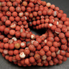 Close-up of red marbled beads on a dark background