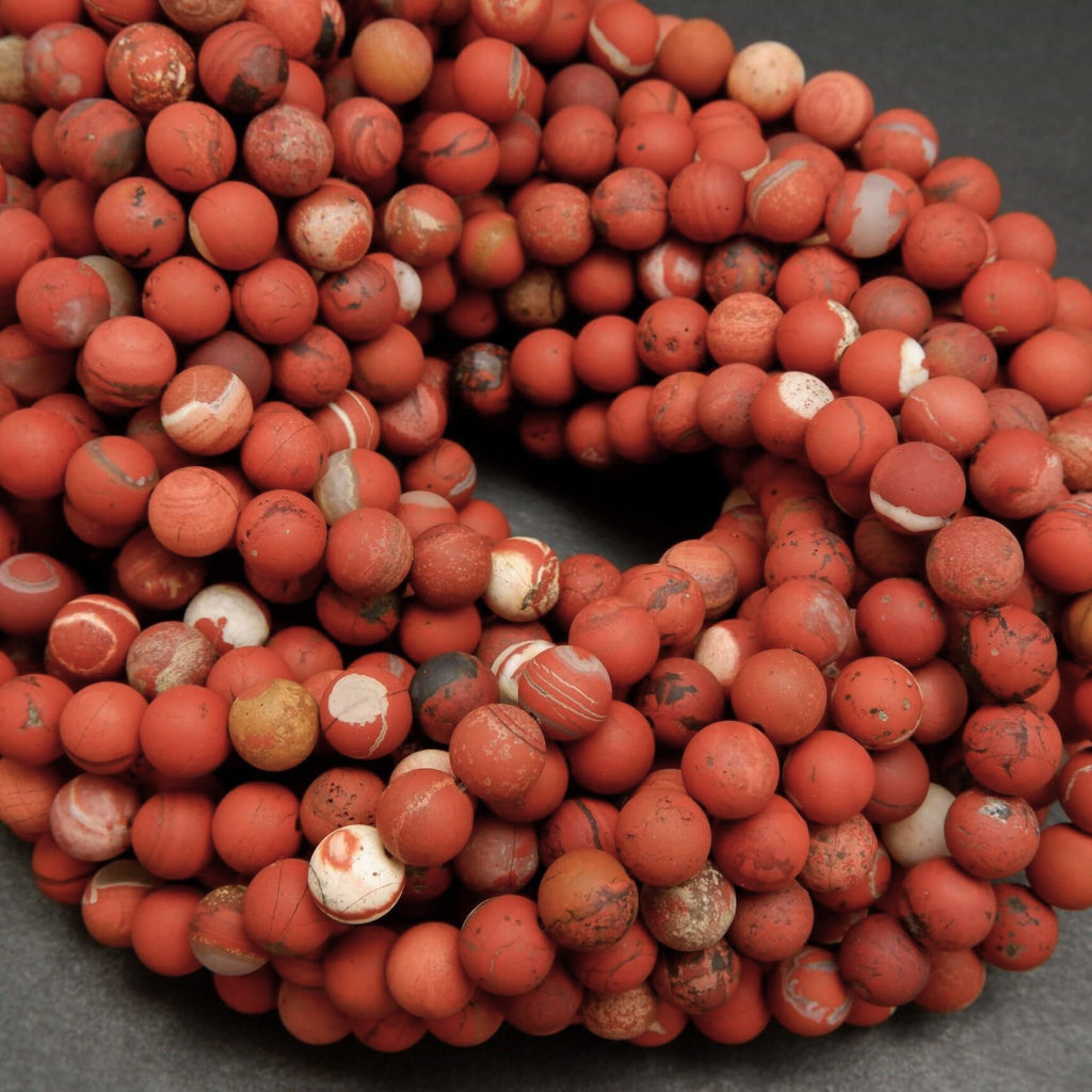 Close-up of red marbled beads on a dark background