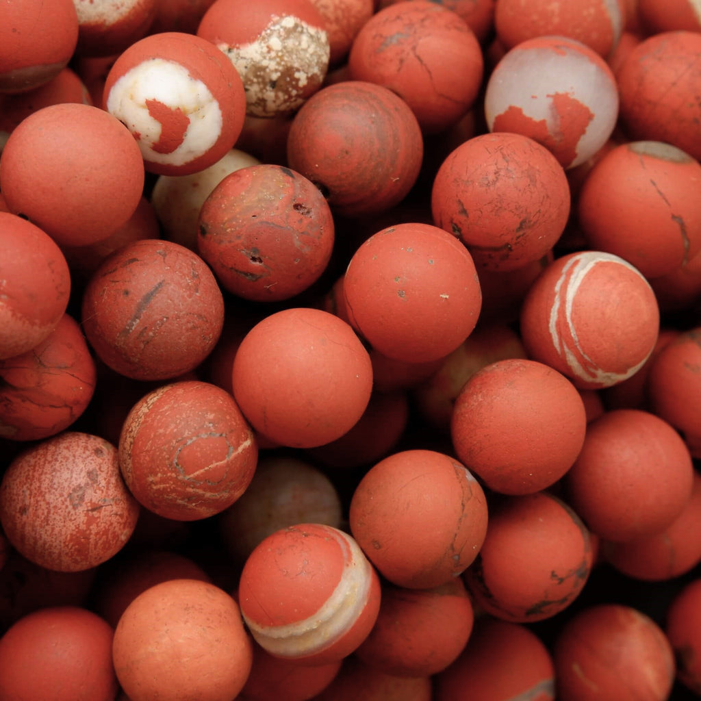 Close-up of a pile of red and white marbled balls