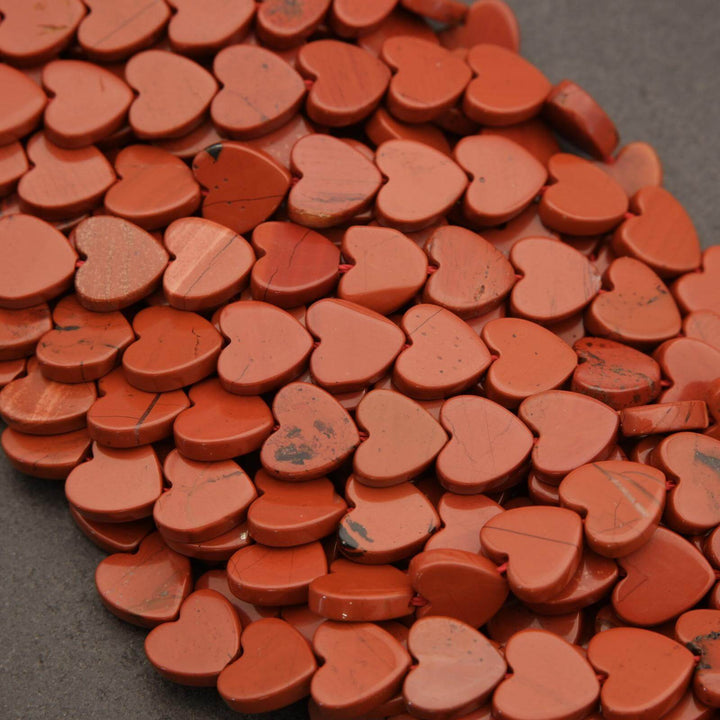 Collection of red heart-shaped objects on a dark surface