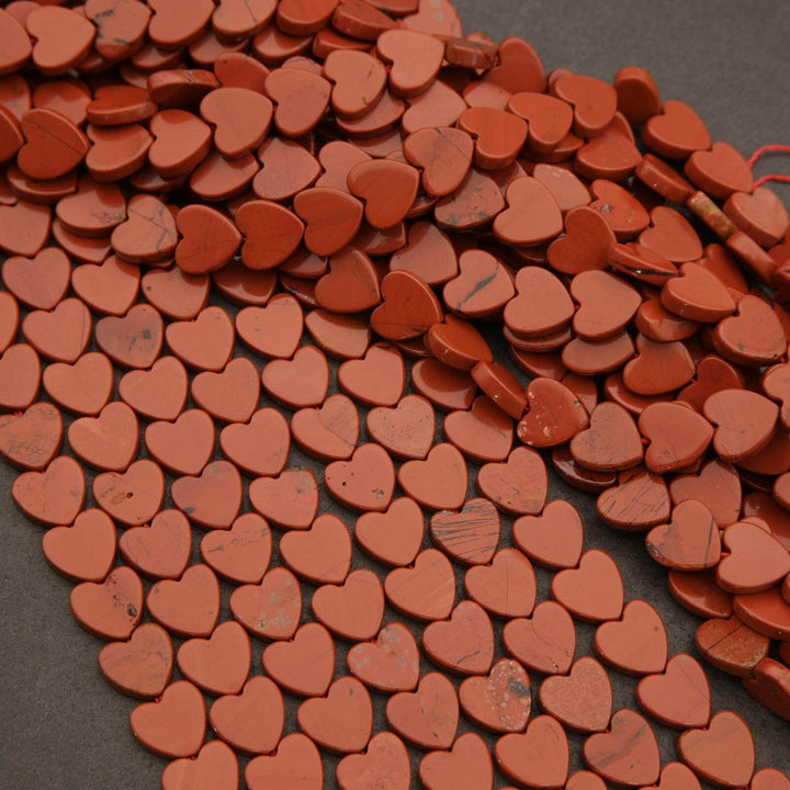 Red heart-shaped stones on a dark surface