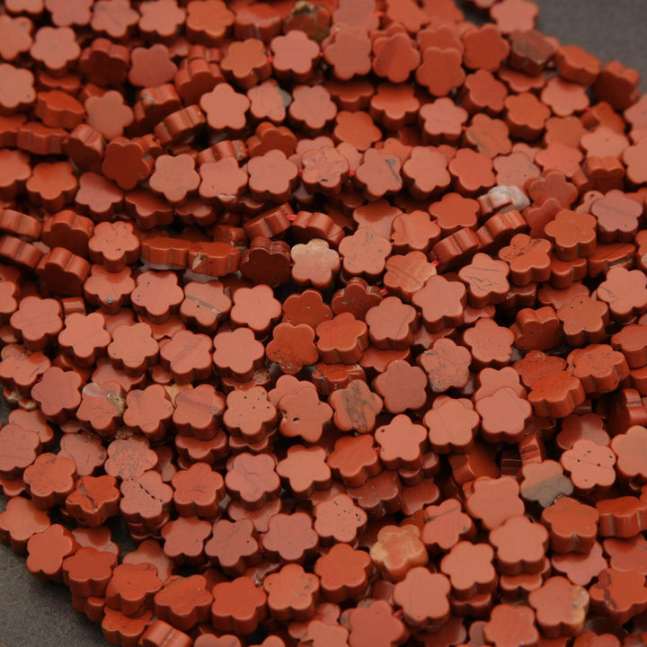 Close-up of a pile of small orange flower-shaped objects.