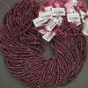 Faceted ruby beads in wine and raspberry hues