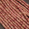 Close-up of pink and red beads on a dark background