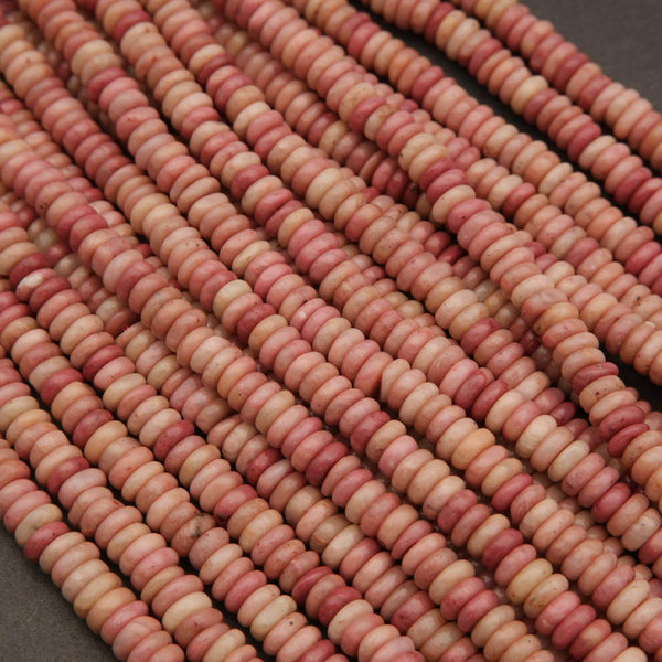 Close-up of pink and red beads on a dark background