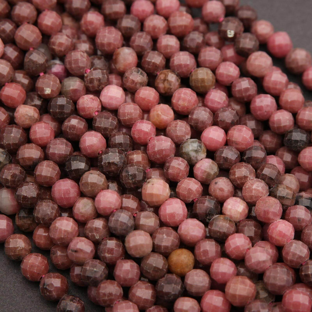 Close-up of pink and brown faceted beads on a dark background