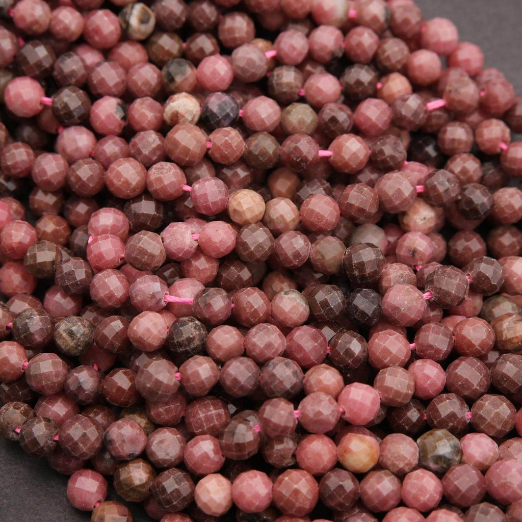 Close-up of faceted pink and brown beads on a dark background