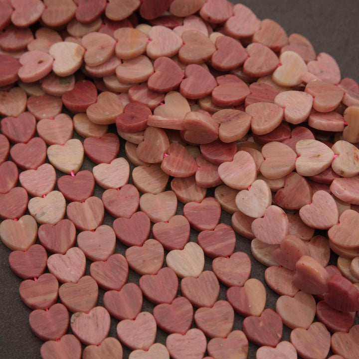 Close-up of pink heart-shaped candies on a dark surface