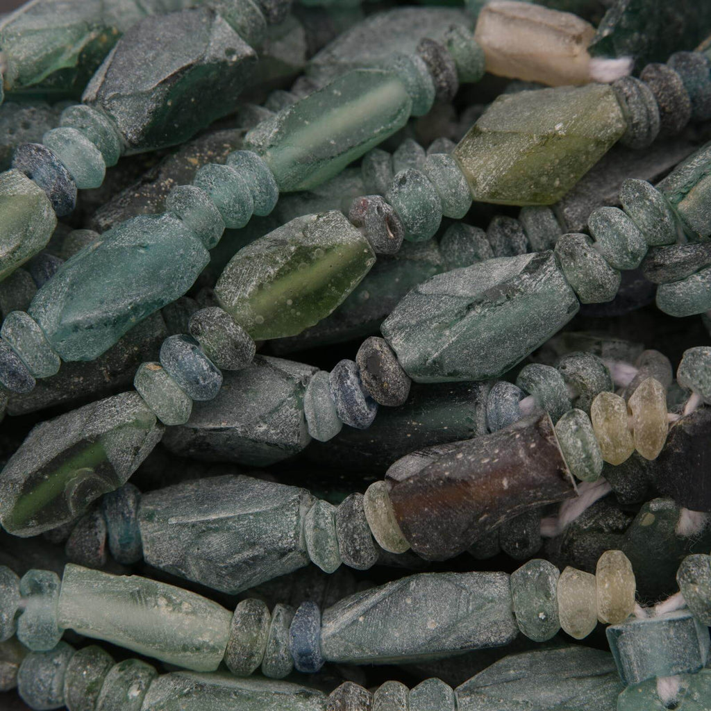 Close-up of green and brown glass beads