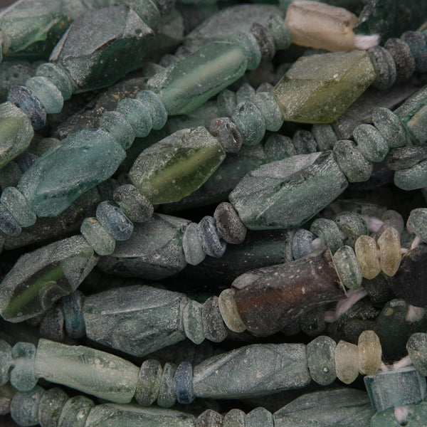Close-up of green and brown glass beads