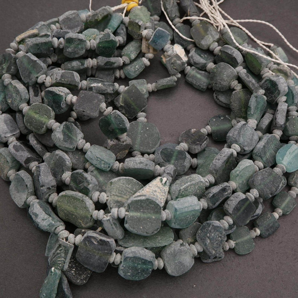 String of green beads on a dark surface