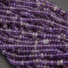 Close-up of purple beads on a gray background