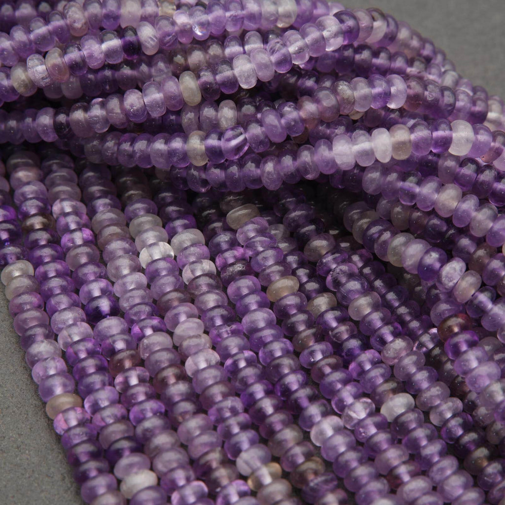 Close-up of purple beads on a gray background