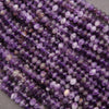 Close-up of purple beads on a gray background