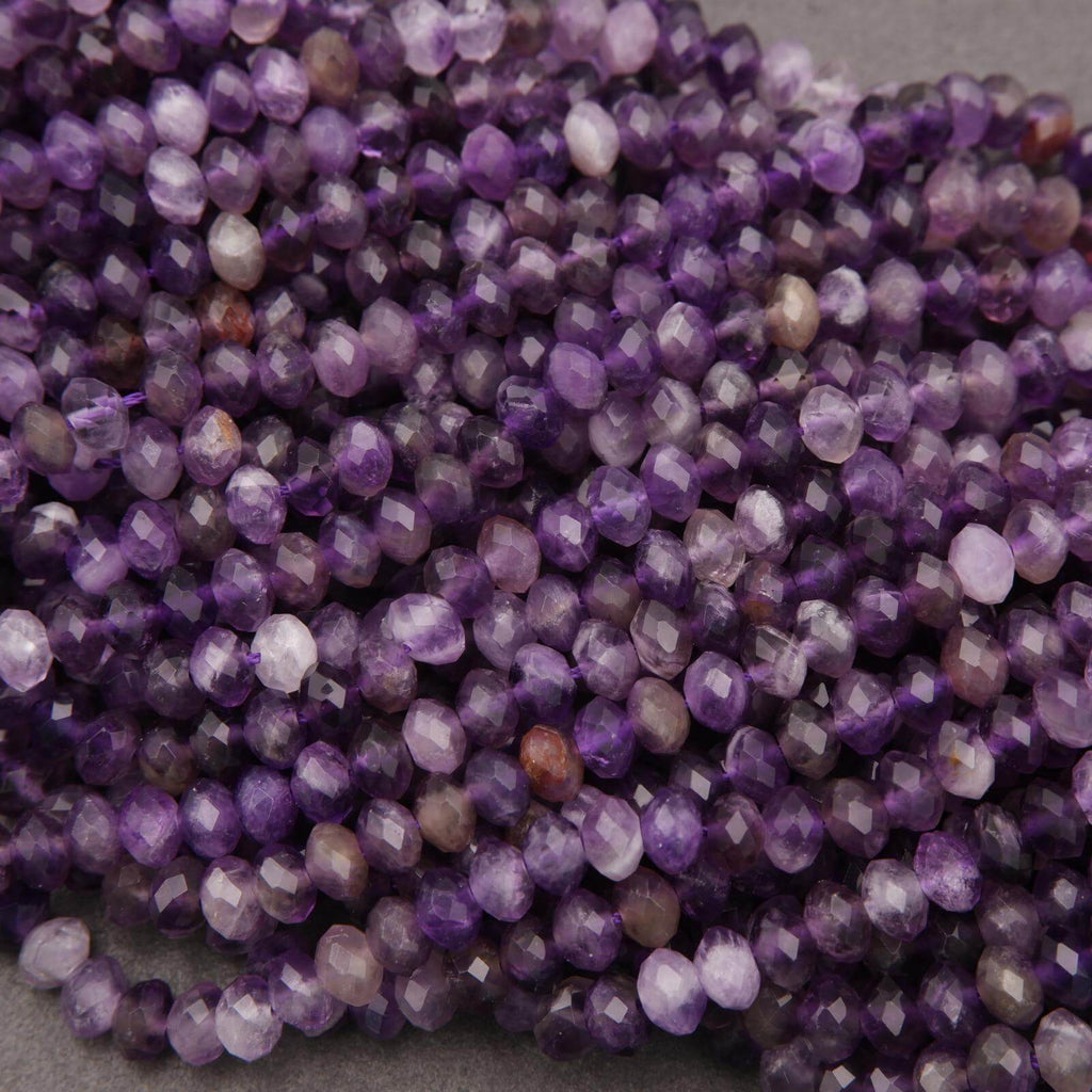 Close-up of purple faceted beads on a gray background