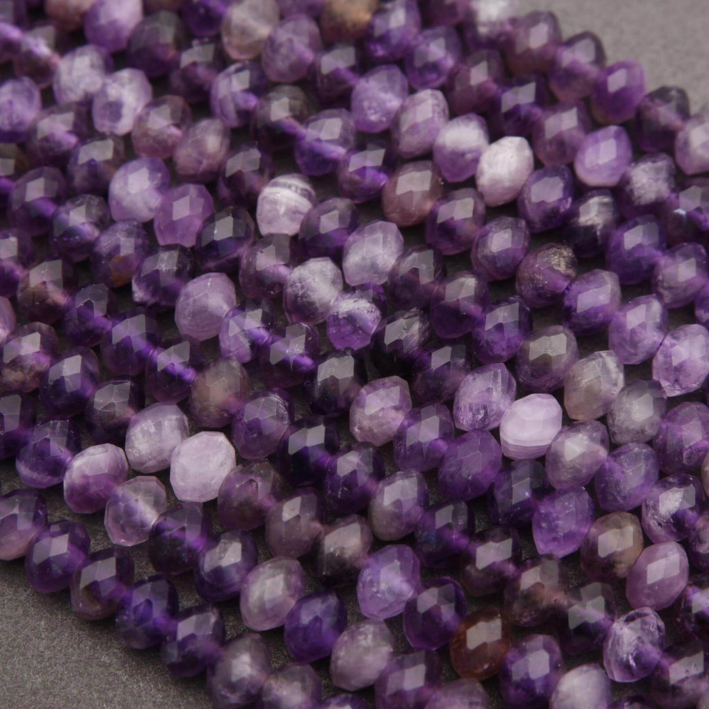 Close-up of purple faceted beads on a gray background