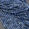Close-up of blue faceted beads on a gray background
