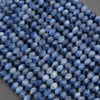 Close-up of blue faceted beads on a gray surface