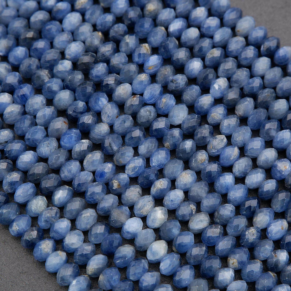 Close-up of blue faceted beads on a gray surface