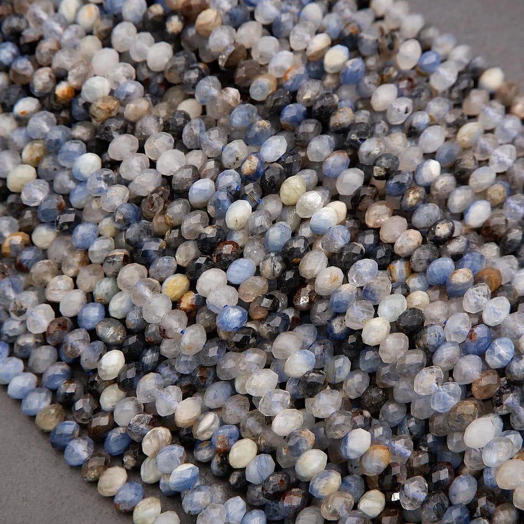 Close-up of small, multicolored stones on a gray surface