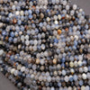 Close-up of faceted gemstones in various colors on a neutral background