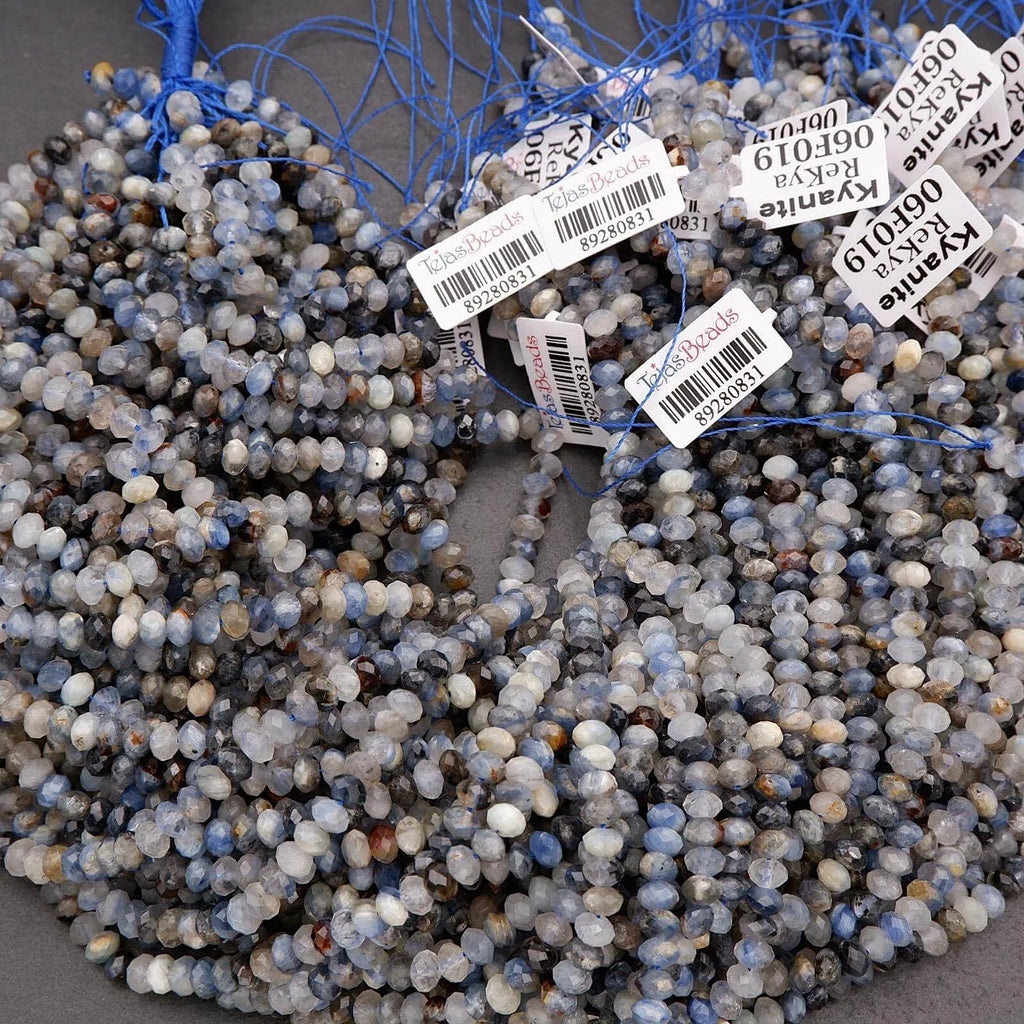String of blue and gray beads with barcodes and labels on a gray surface