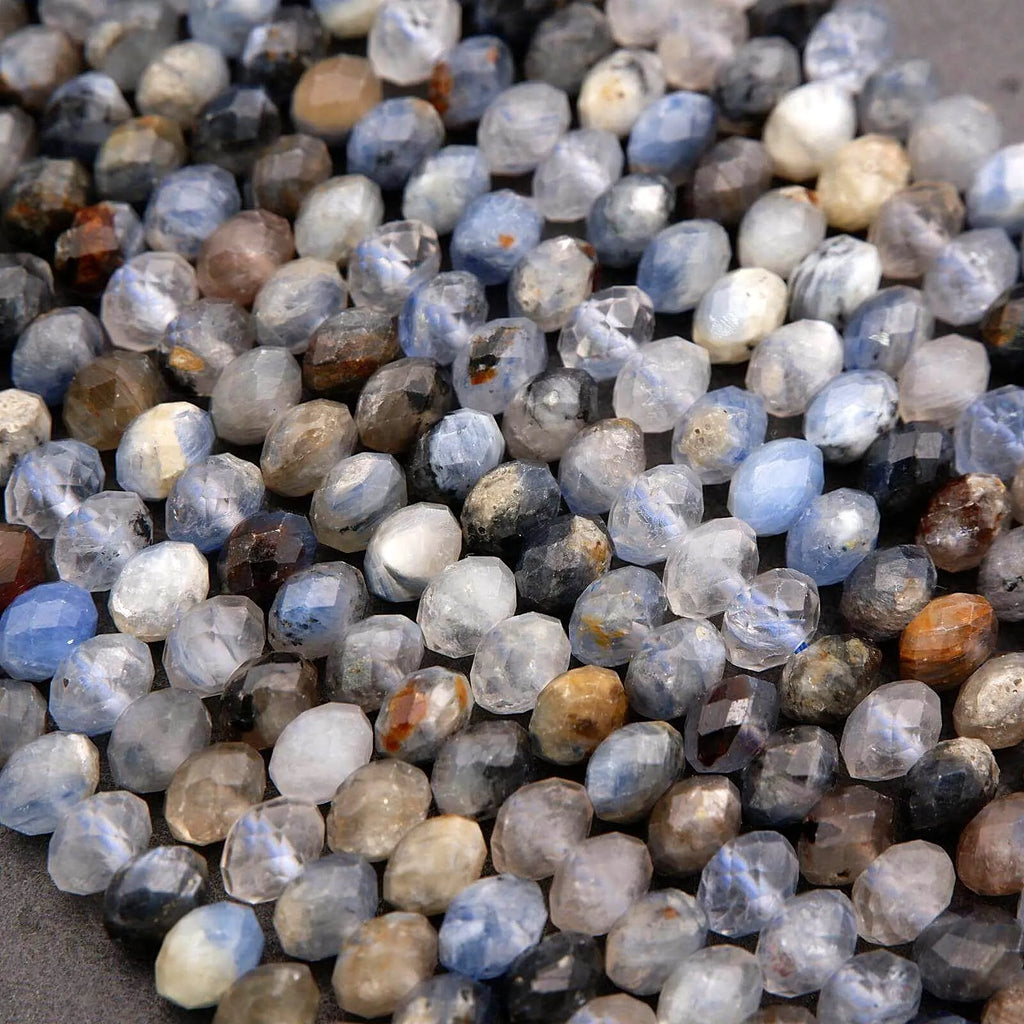 Close-up of small, multicolored stones on a textured surface