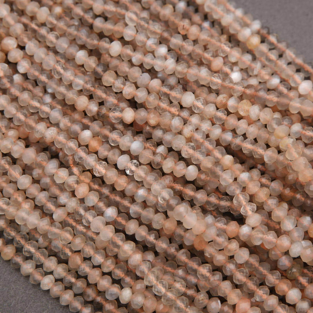 Close-up of beige beads on a thread against a neutral background