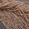 Close-up of strands of small beads on a dark background