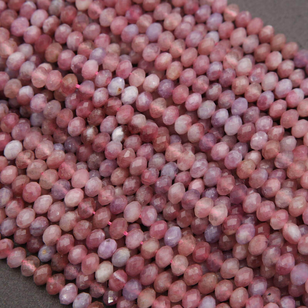 Close-up of pink and purple marbled beads on a gray surface