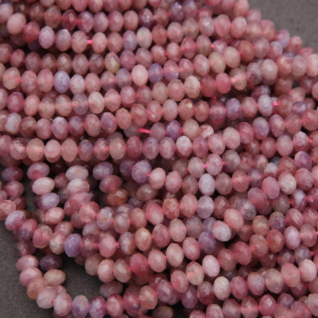 Close-up of pink and purple beads on a gray background