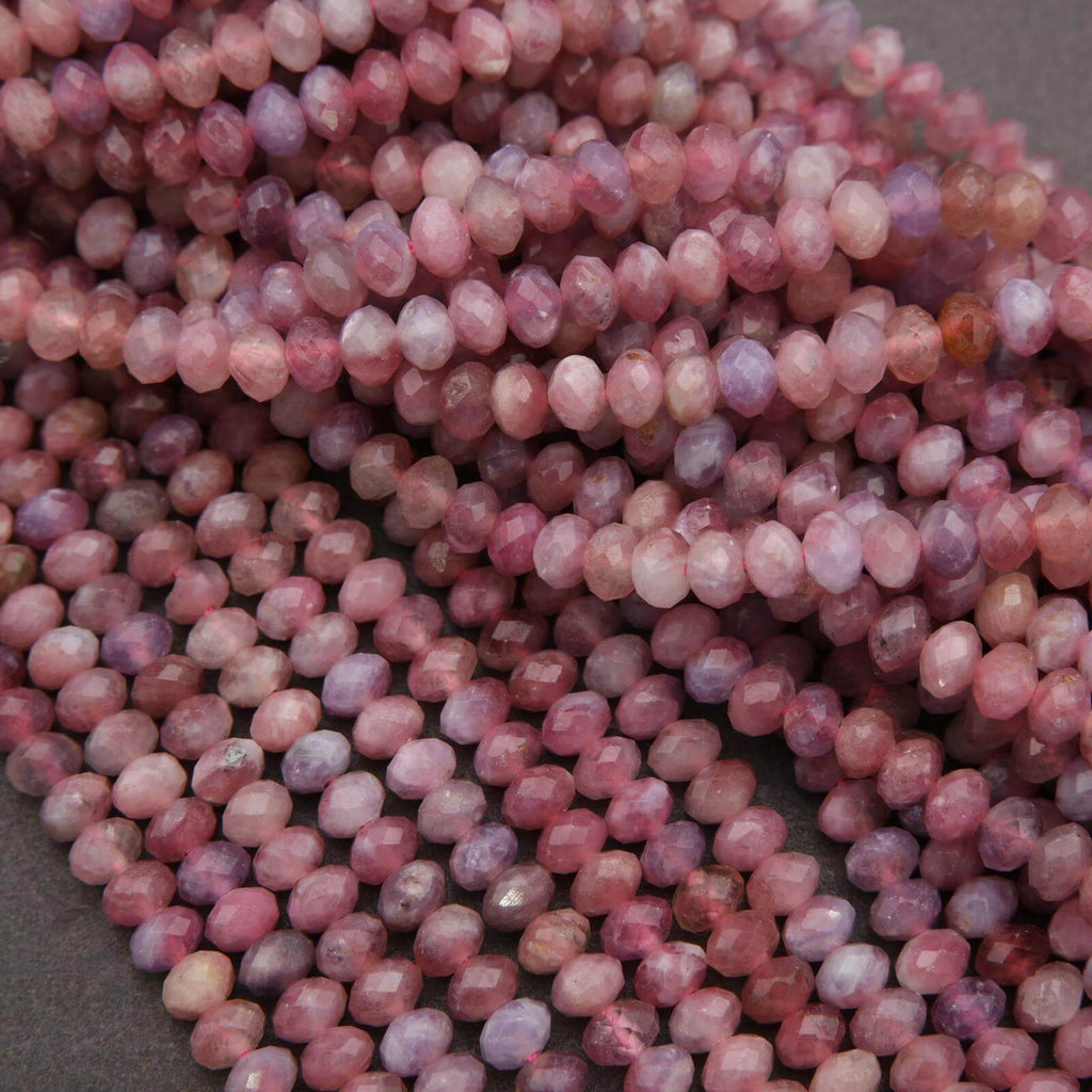 Close-up of pink and purple beads on a gray background