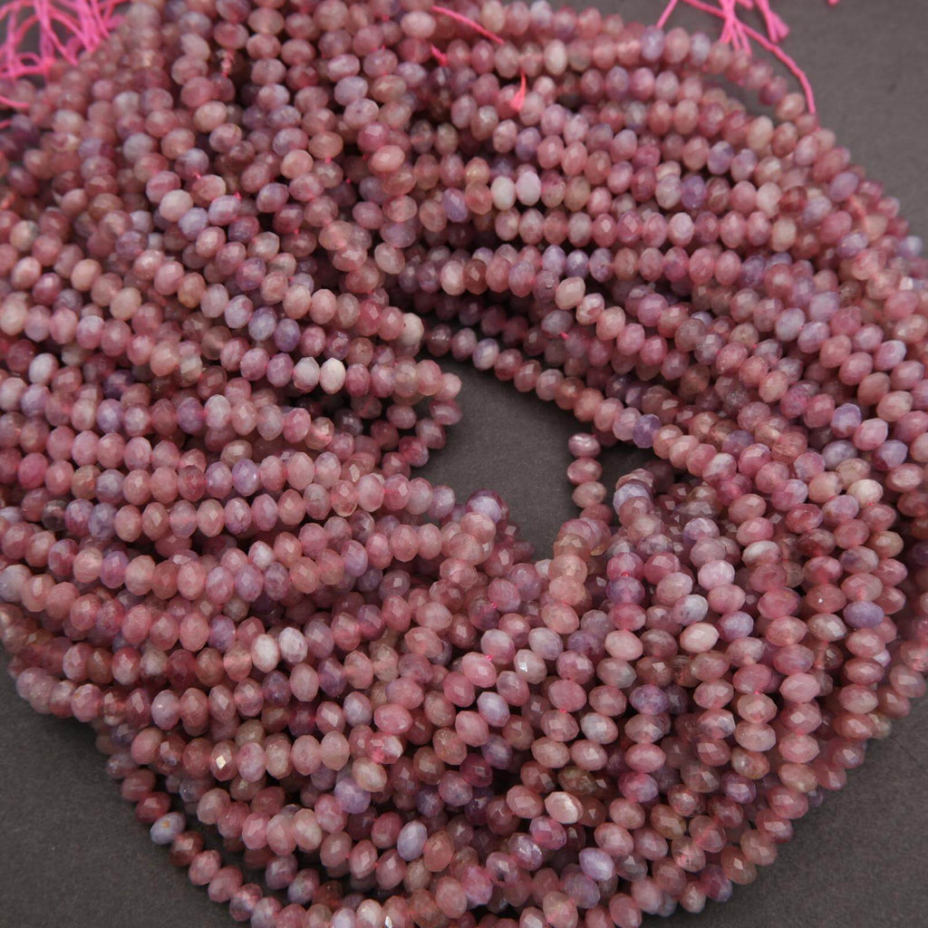 String of pink beads on a dark surface