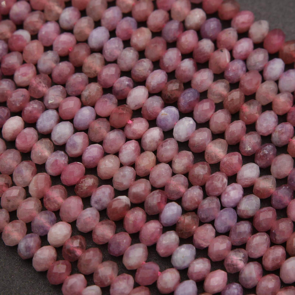 Close-up of pink and purple beads on a dark background